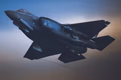 Een F-35 vliegt in de schemering.
