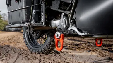 Close-up van de oranje haken die aan de voetsteunen bevestigd zijn.