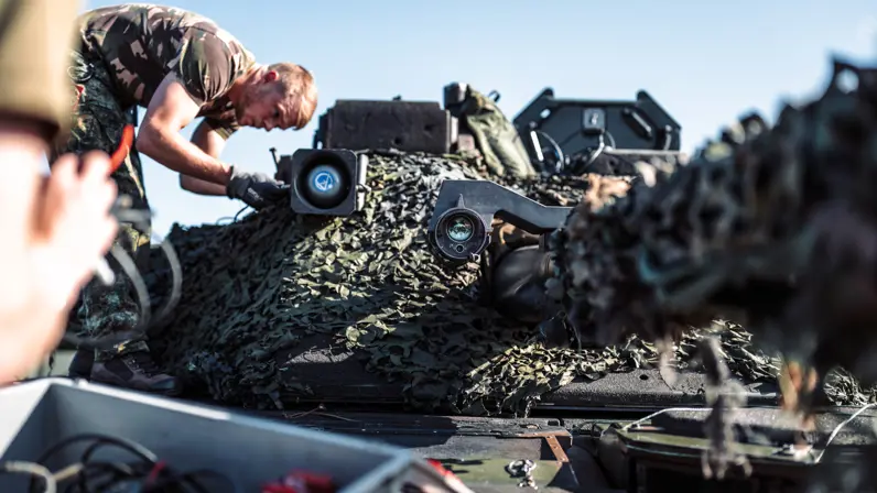 Een militair bovenop een pantservoertuig.
