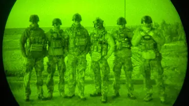 Foto’s van de Live Fire-oefening door een nachtkijker genomen waarbij vanuit een helikopter wordt geschoten.
