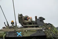 Militair in tank kijkt door verrekijker