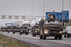 Militaire colonne rijdt over snelweg.