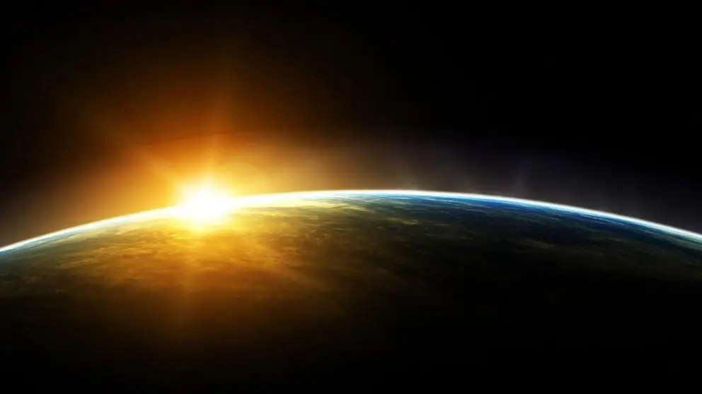 Ruimtefoto van bolling van de aarde met opkomende zon die over deel aarde schijnt.